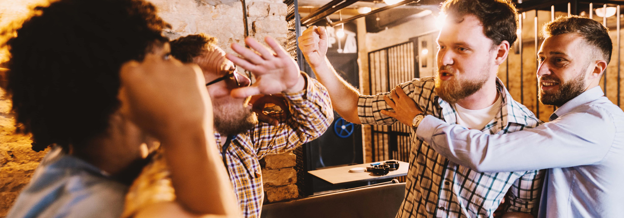 Group of drunk men starting a fight in pub