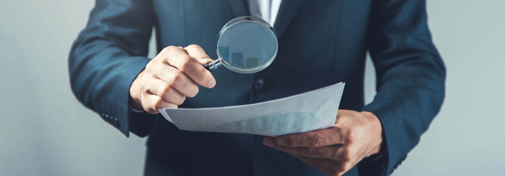 man hand magnifier and document