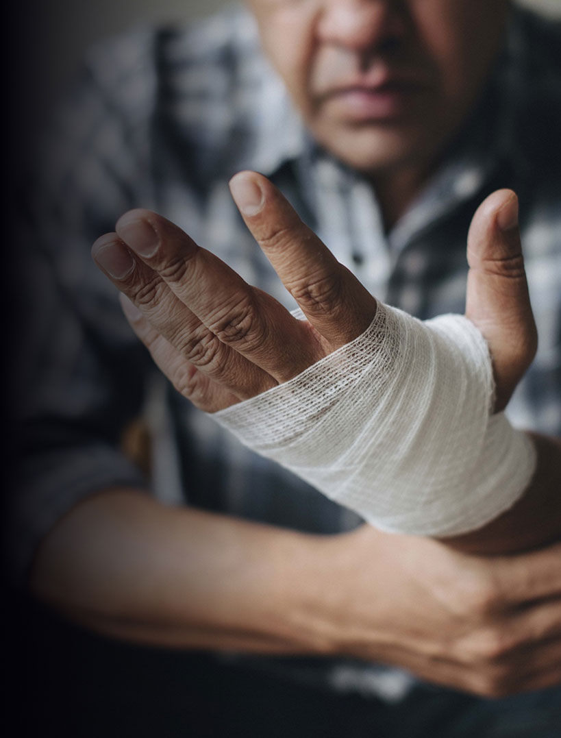 man with a gauze bandage wrapped around his hand