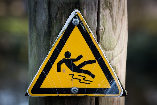 man slipping warning sign