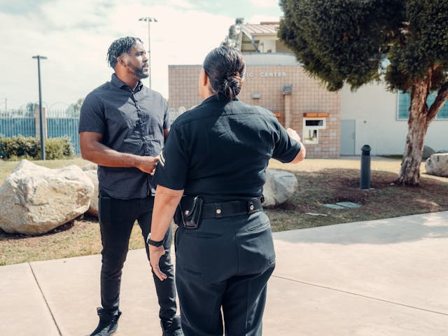 officer and man standing outside of car