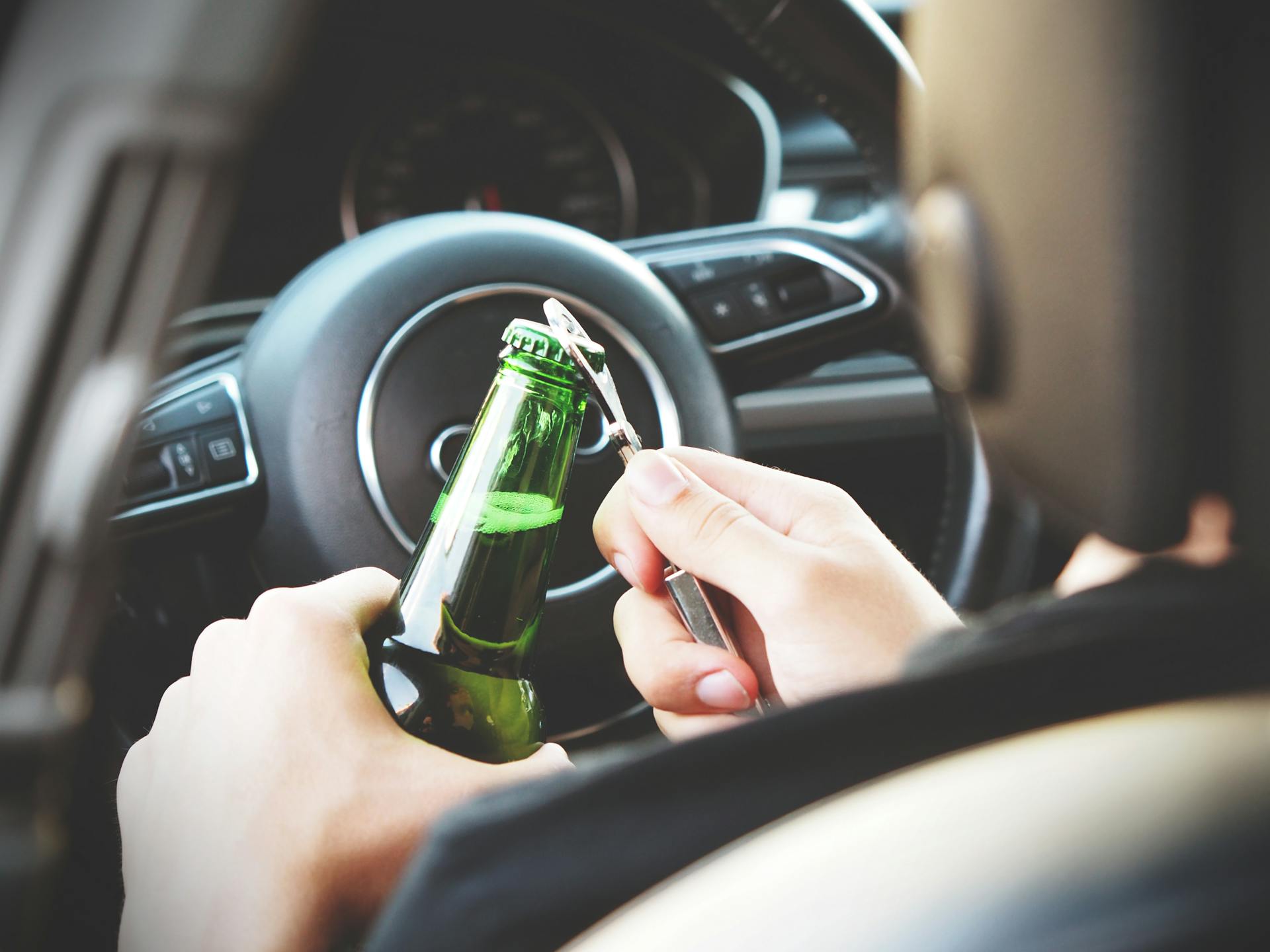 person opening beer in car dui